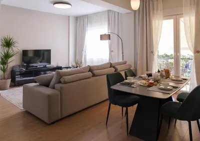 a living room with a couch and a table with food on it at Acropolis Deluxe 2BR Apartment in Athens