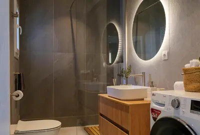 a bathroom with a sink and a toilet and a mirror at Acropolis Deluxe 2BR Apartment in Athens
