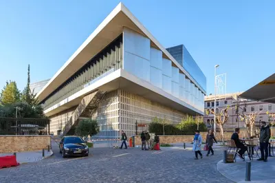 a large building with people walking in front of it at Acropolis Deluxe 2BR Apartment in Athens