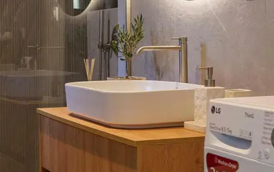 a white sink on a counter in a bathroom at Acropolis Deluxe 2BR Apartment in Athens