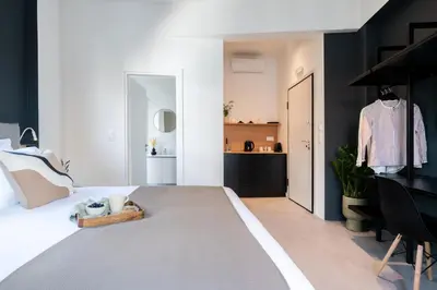 a bedroom with a large white bed with a black wall at Play Psyri Athens a member of Brown Hotels in Athens
