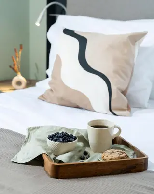 a tray of cookies and a cup of coffee on a bed at Play Psyri Athens a member of Brown Hotels in Athens