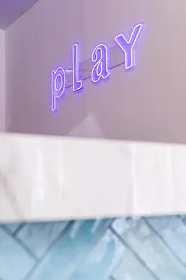 a purple sign that says play on a wall at Play Psyri Athens a member of Brown Hotels in Athens