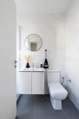 a white bathroom with a toilet and a mirror at Play Psyri Athens a member of Brown Hotels in Athens