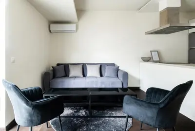 a living room with a couch and two chairs at Elysee apatment 9A in Athens