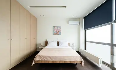 a bedroom with a bed and a large window at Elysee apatment 9A in Athens