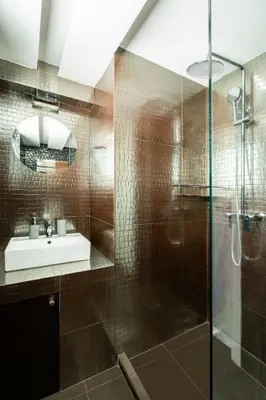 a bathroom with a glass shower and a sink at Elysee apatment 9A in Athens