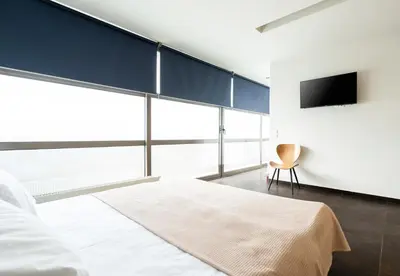 a bedroom with a large bed and a tv at Elysee apatment 9A in Athens