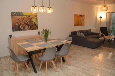 a kitchen and living room with a table and chairs at Twins apartments - Concert Hall in Athens