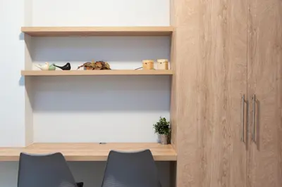 a room with two chairs and a wooden cabinet at Twins apartments - Concert Hall in Athens