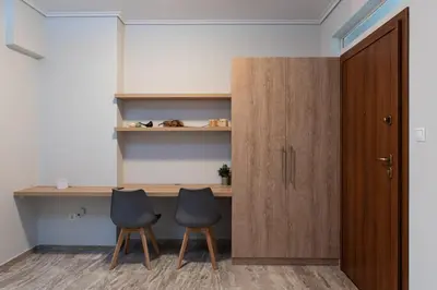 a room with two chairs and a desk and a door at Twins apartments - Concert Hall in Athens