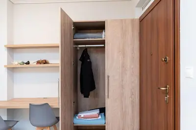 a room with a closet with a wooden door at Twins apartments - Concert Hall in Athens
