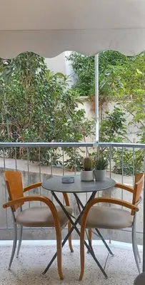 a table and two chairs with a table and an umbrella at Αlpha- Αthenian apartments in Athens