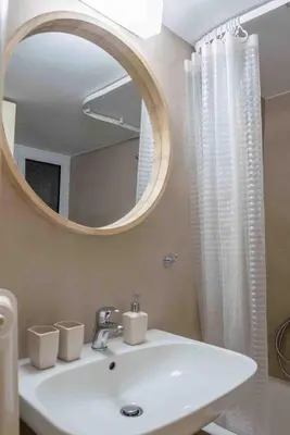 a bathroom with a white sink and a mirror at Αlpha- Αthenian apartments in Athens