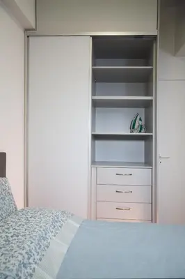 a bedroom with a bed and a closet at Unforgettable Acropolis View in Athens