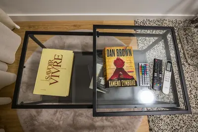 a glass table with two books on top of a table at Unforgettable Acropolis View in Athens