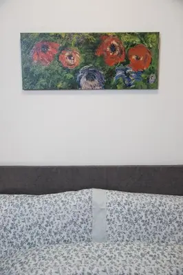 a bed with two paintings on the top of it at Unforgettable Acropolis View in Athens