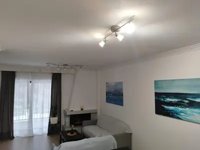 a living room with a ceiling fan and a couch at S & K Apartment free indoor parking in Athens