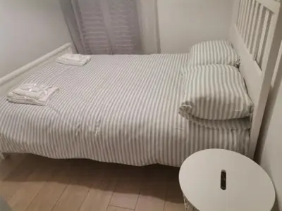a small bed and a chair in a room at S & K Apartment free indoor parking in Athens