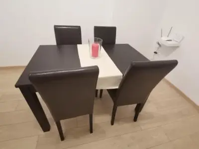 a black dining room table with chairs and a drink on it at S & K Apartment free indoor parking in Athens
