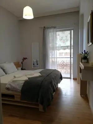 a bedroom with a bed and a large window at Roulas house Διαμέρισμα Κέντρο Σεπόλια ΜΕΤΡΟ in Athens
