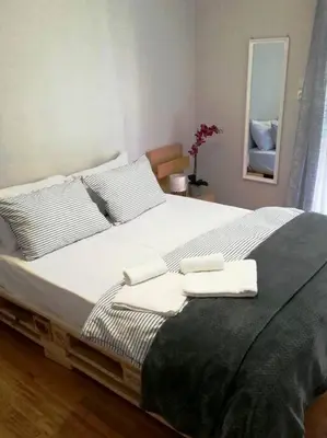 a bedroom with a large bed with two towels on it at Roulas house Διαμέρισμα Κέντρο Σεπόλια ΜΕΤΡΟ in Athens