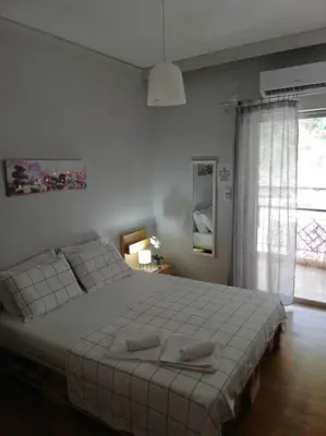 a bedroom with a large white bed with two pillows at Roulas house Διαμέρισμα Κέντρο Σεπόλια ΜΕΤΡΟ in Athens