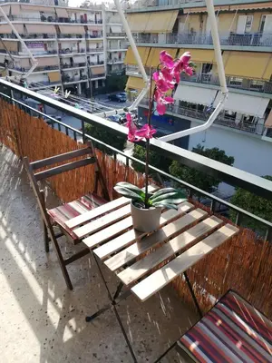 a table with a potted plant on a balcony at Roulas house Διαμέρισμα Κέντρο Σεπόλια ΜΕΤΡΟ in Athens