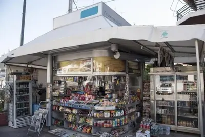 a store front of a store with an umbrella at Roulas house Διαμέρισμα Κέντρο Σεπόλια ΜΕΤΡΟ in Athens