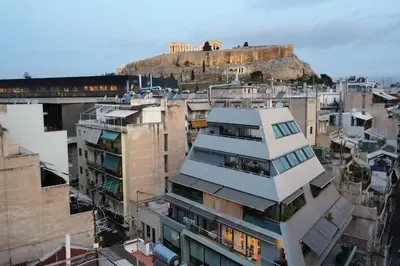 a group of buildings in a city with a hill at Modern Loft Build on Acropolis Ruins in Athens