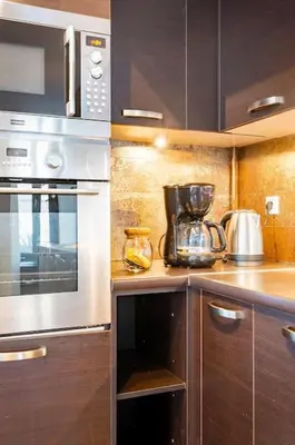 a kitchen with a stove and a microwave at Modern Loft Build on Acropolis Ruins in Athens