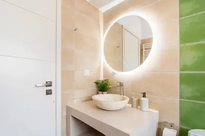 a bathroom with a sink and a mirror at Modern Loft Build on Acropolis Ruins in Athens