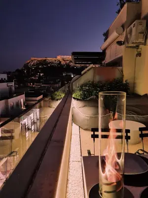 a glass vase sitting on top of a balcony at Heated Plunge Pool & Firepit Acropolis Penthouse in Athens