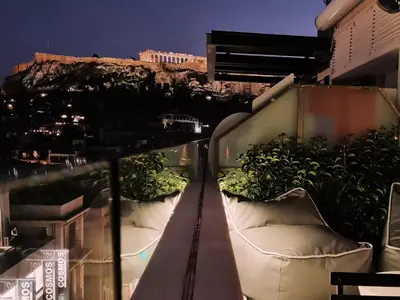 a view of a balcony with plants on it at Heated Plunge Pool & Firepit Acropolis Penthouse in Athens