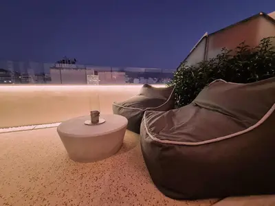 two couches sitting on the side of a building at Heated Plunge Pool & Firepit Acropolis Penthouse in Athens