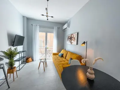 a living room with a yellow couch and a table at Luxury apartment close to metro & Akropolis- Cielo Homes in Athens