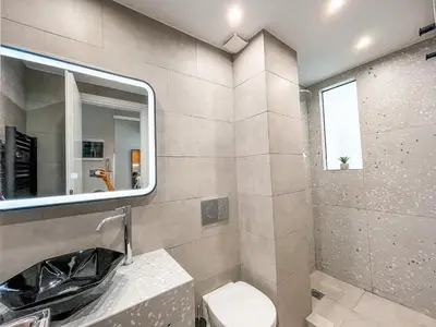 a bathroom with a sink and a mirror and a toilet at Luxury apartment close to metro & Akropolis- Cielo Homes in Athens