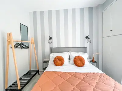 a bedroom with a bed with orange pillows on it at Luxury apartment close to metro & Akropolis- Cielo Homes in Athens