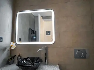a bathroom with a black sink and a mirror at Luxury apartment close to metro & Akropolis- Cielo Homes in Athens