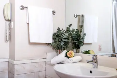 a bathroom with a sink and a mirror at Athens Zafolia Hotel in Athens