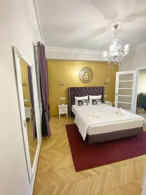 a bedroom with a large bed and a chandelier at Check Point - Acropolis View in Athens