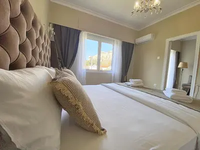 a bedroom with a large bed and a window at Check Point - Acropolis View in Athens