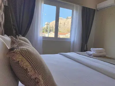 a bedroom with a bed and a window at Check Point - Acropolis View in Athens