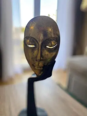 a statue of a mask with eyes on it at Check Point - Acropolis View in Athens
