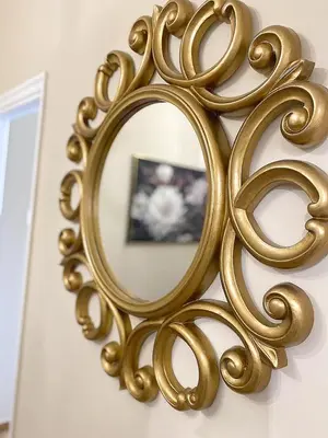 a gold mirror on a wall with a picture at Check Point - Acropolis View in Athens