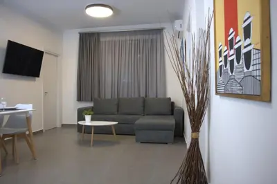 a living room with a couch and a table at Synathens II - Apartments & Studios in Athens