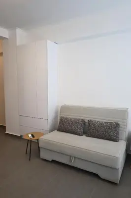 a living room with a couch and a table at Synathens II - Apartments & Studios in Athens