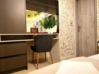 a bedroom with a desk with a chair and a mirror at Elia Studio in Athens