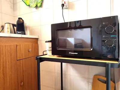 a microwave sitting on top of a table at Elia Studio in Athens