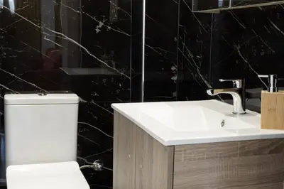 a bathroom with a white sink and a toilet at Comfort Sunny Hub with 2 bdr in Athens